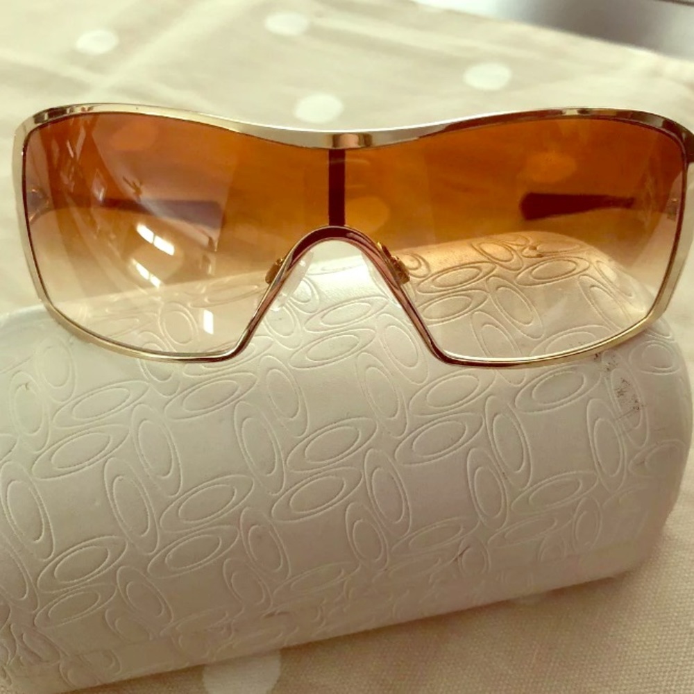 Women’s gold rimmed Oakley’s
